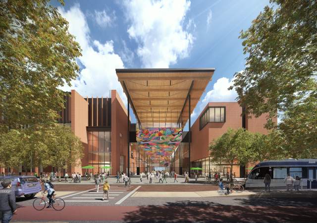 Austin Convention Center rendering showing the new building's West Entrance from street level with pedestrians, cyclists and a light rail along the street. The multi-story building includes a mural along the ceiling of the entrance
