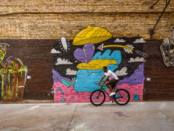 man biking through Black Cat Alley