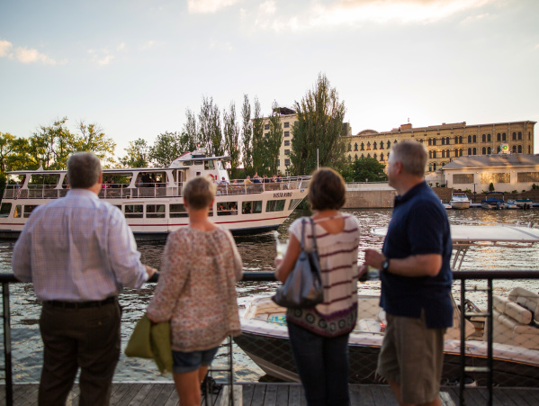 people looking at the VistaKing ship on the river in the Third Ward