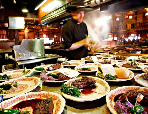 many dishes of steaks plated ready to be served at the big texan steak ranch in amarillo, texas