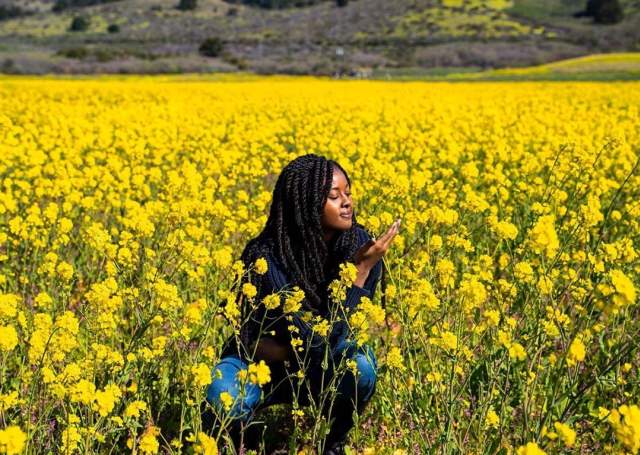 Girl posing in mustard flower field in half moon bay