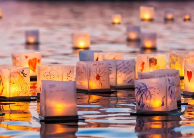 Lanterns on water at sunset