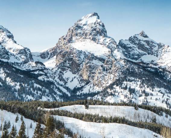 Grand Tetons with snow and blue skies