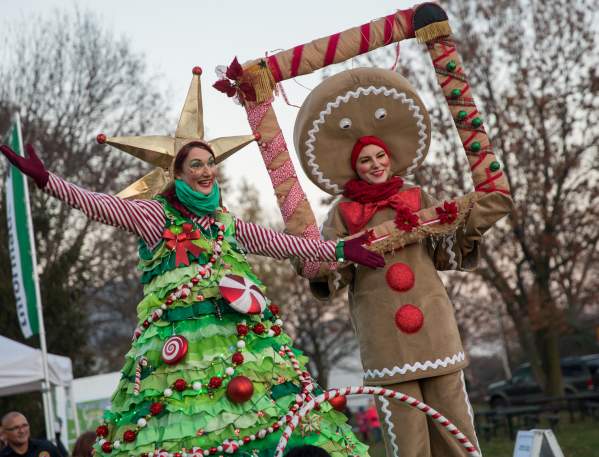 People dressed as a Christmas tree and Gingerbread man at the Tree Lighting Ceremony.