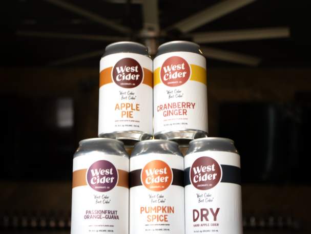 5 cans of West Cider in various flavors are stacked