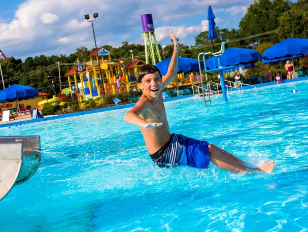 young boy having fun splashing around at a pool in Cincinnati