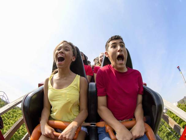 young couple having fun riding a roller coast in Cincinnati