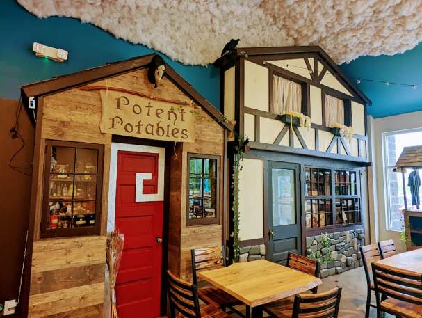 Image is of the facade of a fake "Potent Potato's" store inside the brewery.
