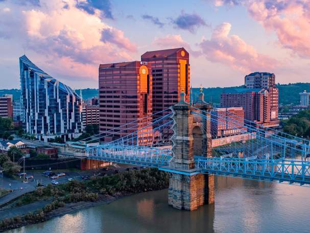 The skyscrapers, The Ascent and Rivercenter Towers behind the Roebling Bridge and Ohio river on a sunny day