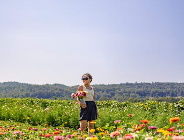 woman posing in a flower field in the springtime