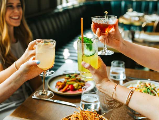 People toasting their drinks at Granddam restaurant in Lexington, Kentucky