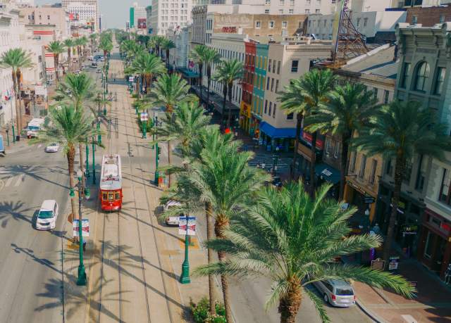 Streetcars Roll Along Canal Street - Downtown New Orleans