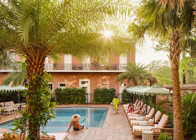 People relax by the pool at the Hotel St. Vincent, a boutqiue hotel in the Lower Garden District of New Orleans