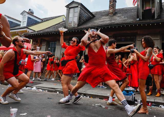 Red Dres Run participants outside of Lafitte's Blacksmith Shop in the French Quarter