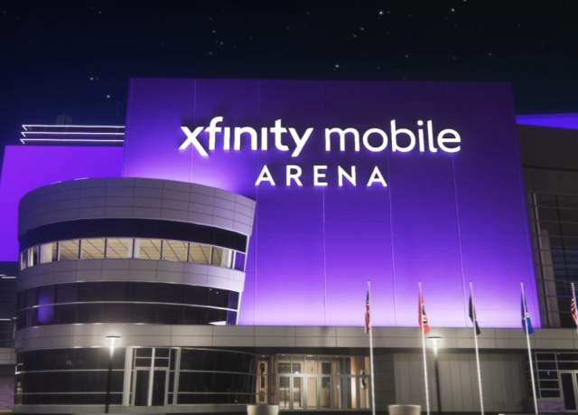 Exterior of an indoor at night with a glowing sign that reads Xfinity Mobile Arena