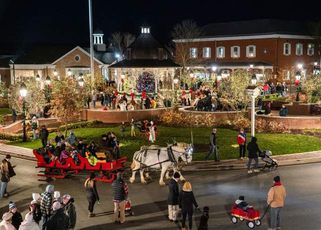 Aerial view of people and horse drawn carriages during the holidays in Ligonier's downtown