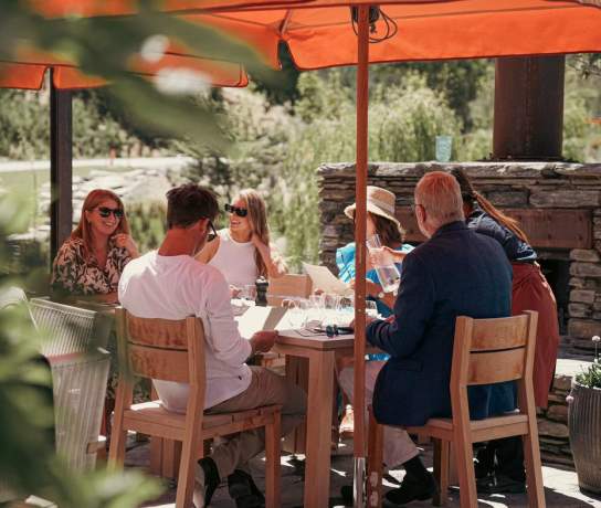 A group of friends enjoying lunch in the sun at Ayrburn