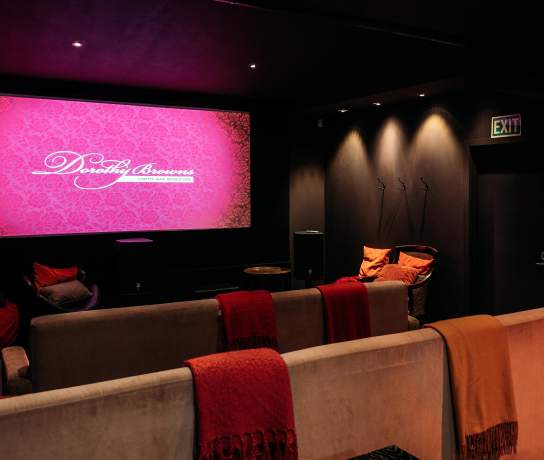 Inside of a boutique cinema with couches and blankets
