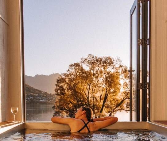 A lady enjoying the evening sunshine in a Driftaway Holiday Park Hot Tub