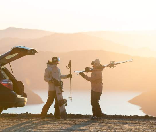 Friends unpack their car for a day of skiing at Treble Cone