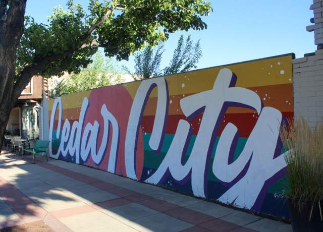 A vibrant mural in primary colors with Cedar City painted in the foreground.