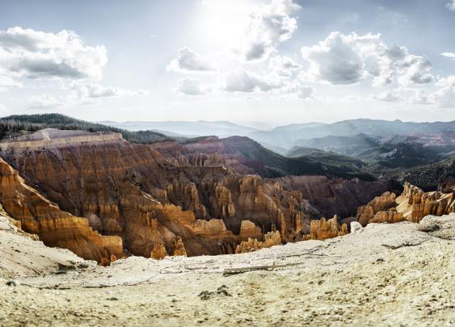 Vibrant red rock formations below a blue sky from the Spectra Point overview at