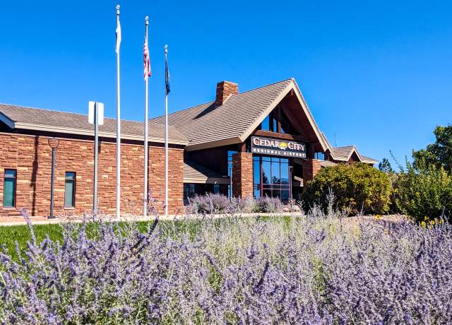 The Cedar City Regional Airport with a spot of bright purple flowers in front.