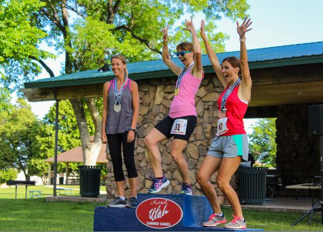 Three women celebrate their medals at the Utah Summer Games in Cedar City, Utah.