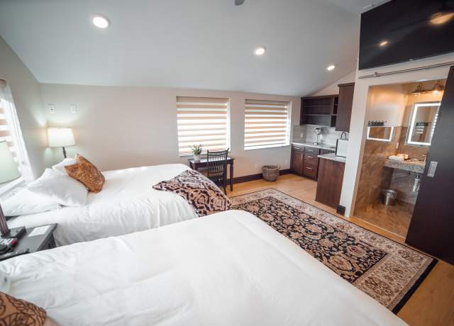 Interior of a hotel room with two beds at Iron Springs Resort in Cedar City, UT