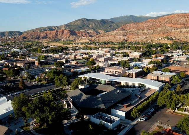 Aerial view of Cedar City Utah looking down on the Beverley Center for the Arts with the Red Hill visible in the background.
