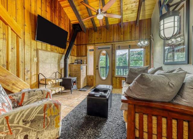 Cozy interior of a wood cabin with woodburning stove and comfortable furniture