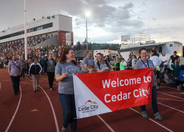 Our visitor center team dressed in matching Cedar City t-shirts walks in the athlete parade at the Utah Summer Games Opening Ceremonies.