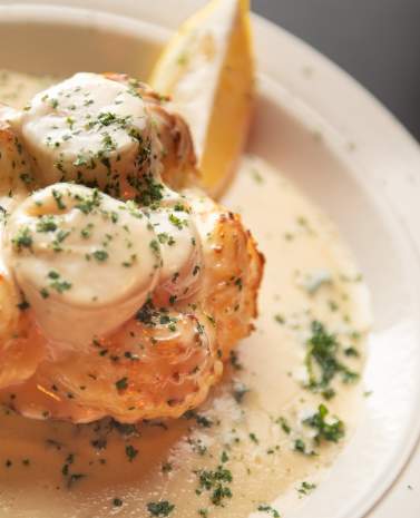 A well-plated dish featuring chicken topped with mushrooms and smothered with a light, creamy sauce