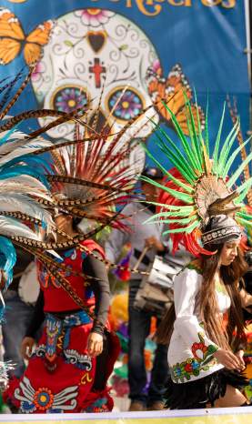Performing Mayan dancers on stage at Dia de los Muertos Event