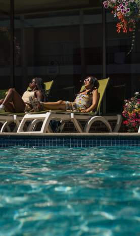 People Relaxing at Coast Capri Hotel Pool