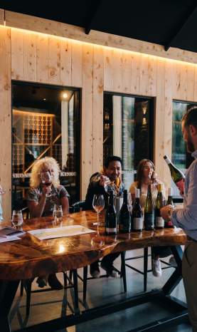 A group of people attending a wine tasting at Kinross in Gibbston near Queesntown