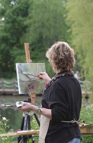 Woman painting in plein air at the Monet Garden at the Overland Park Arboretum and Botanical Gardens