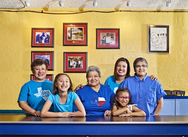 Regina Estrada and female family members smile for a portrait inside Joes Bakery and Coffee Shop