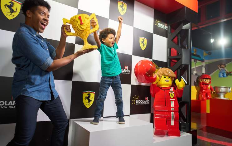 Man and Child holding Trophy at Ferrari Build and Play at LEGOLAND Florida