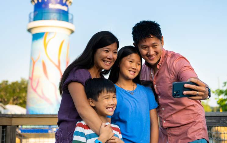 Family in front of SeaWorld lighthouse