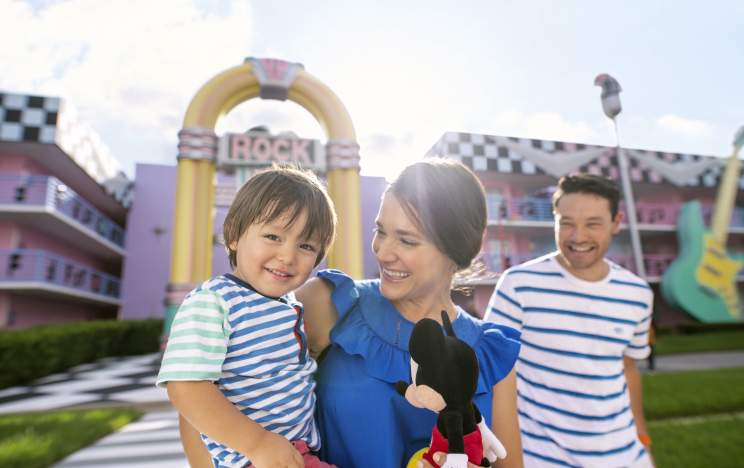 Disney's All-Star Music Resort family in front of resort