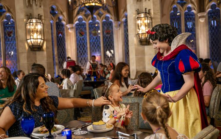 Snow White greeting guests at Akershus Royal Banquet Hall during a Disney dining experience.