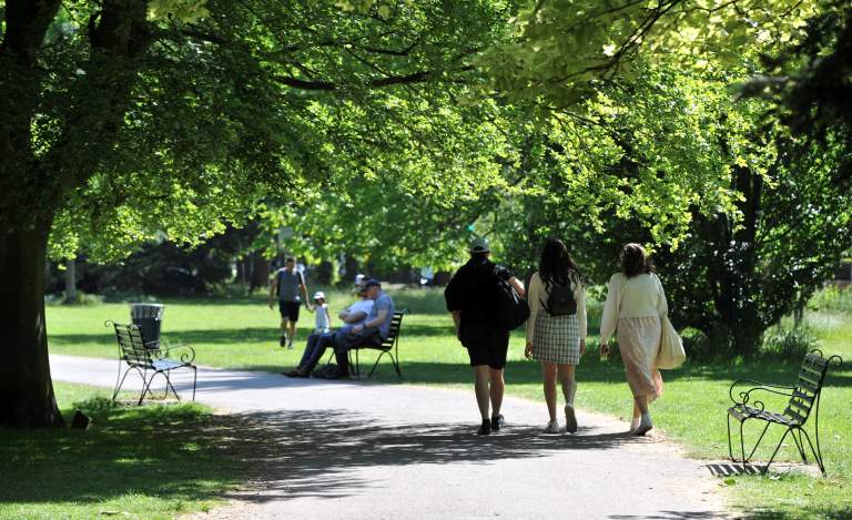 People walking through Cheltenham parks and gardens.