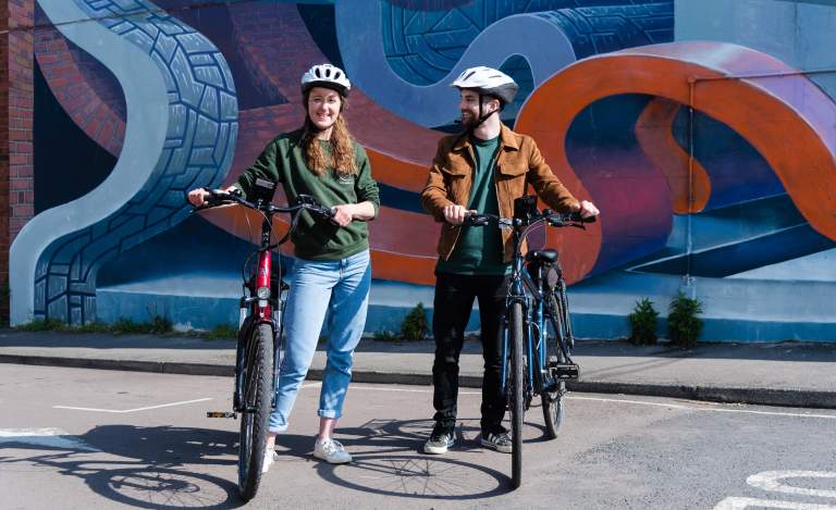 Visitors riding bikes in Cheltenham.