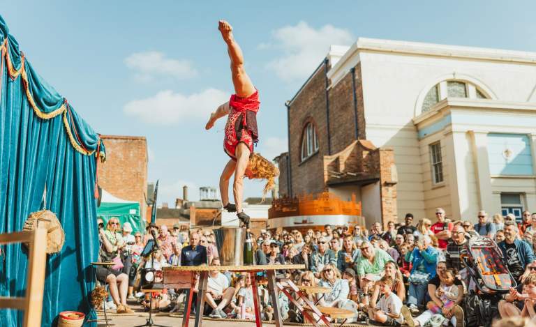 Gymnastics performer wowing the crowd in Zebedee's Yard