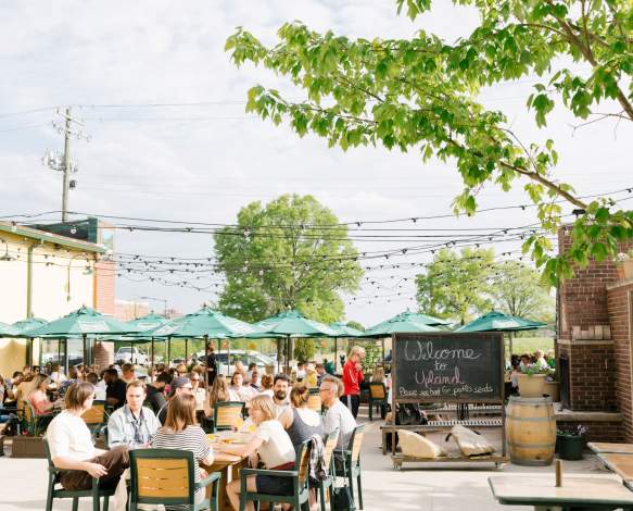 People dining on the patio at Upland