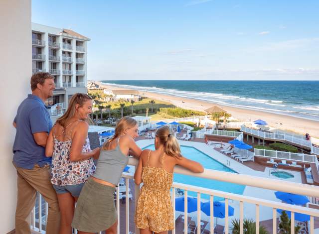Family overlooking balcony at Lumina on Wrightsville Beach, a Holiday Inn Resort