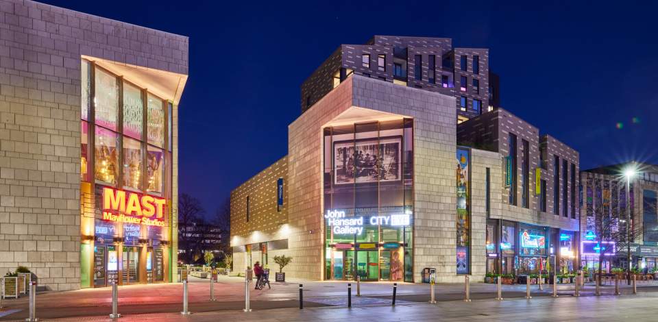 The cultural quarter at night showing John Hansard Gallery and Mayflower Studios buildings with signage lit up