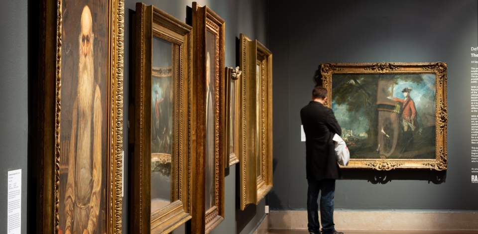 Person looking at peices of art at Southampton City Art Gallery