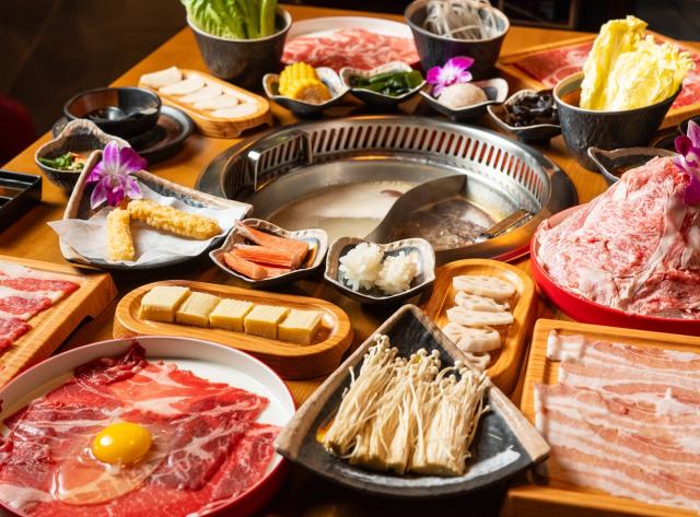 Beef, Chicken, and Veggie Options on a table surrounding the Hot Pot